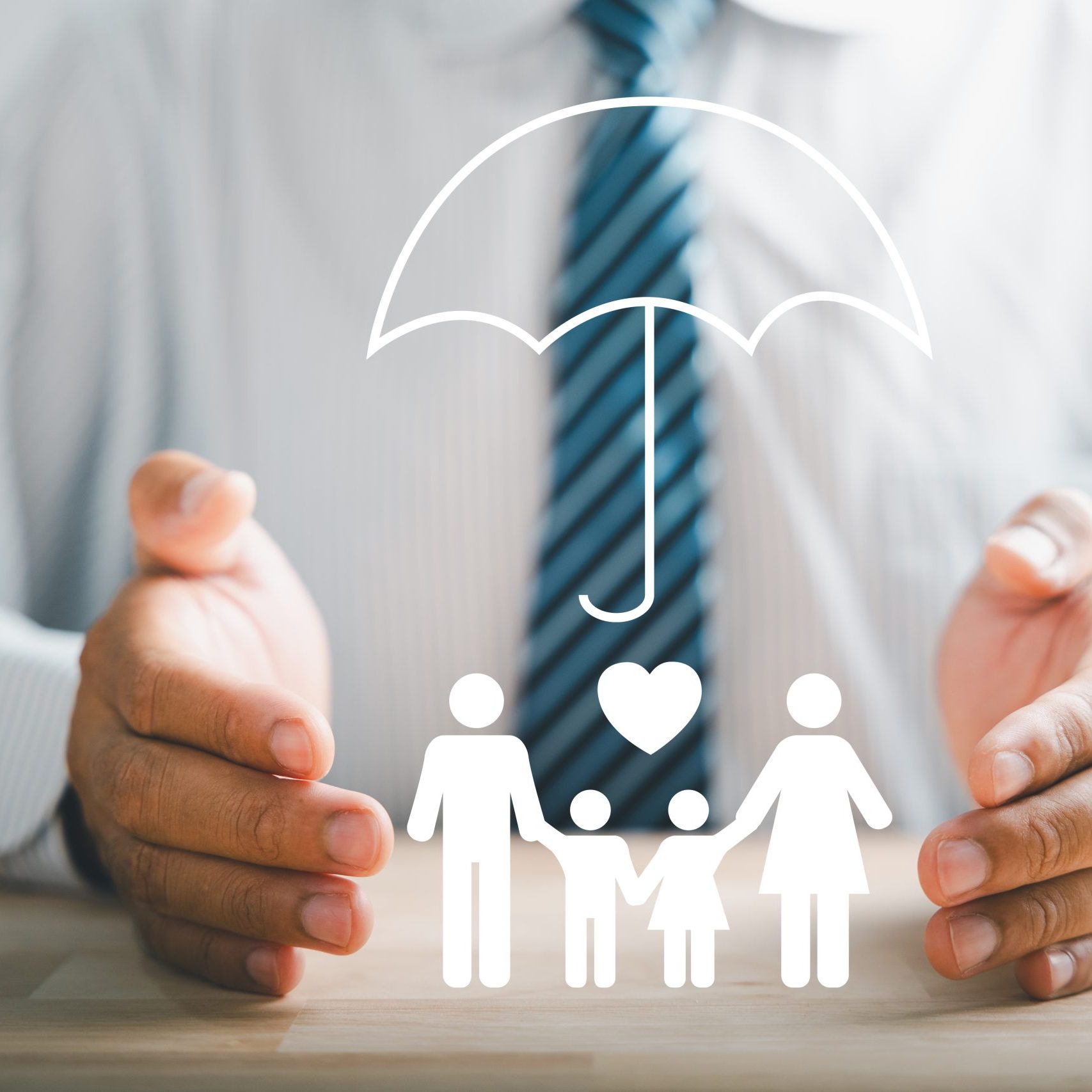 Insurance concepts, a businessman protective gesture beside a silhouette of a young family. Icons for family, life, health, and house insurance. Depicting family life insurance and policy assurance.