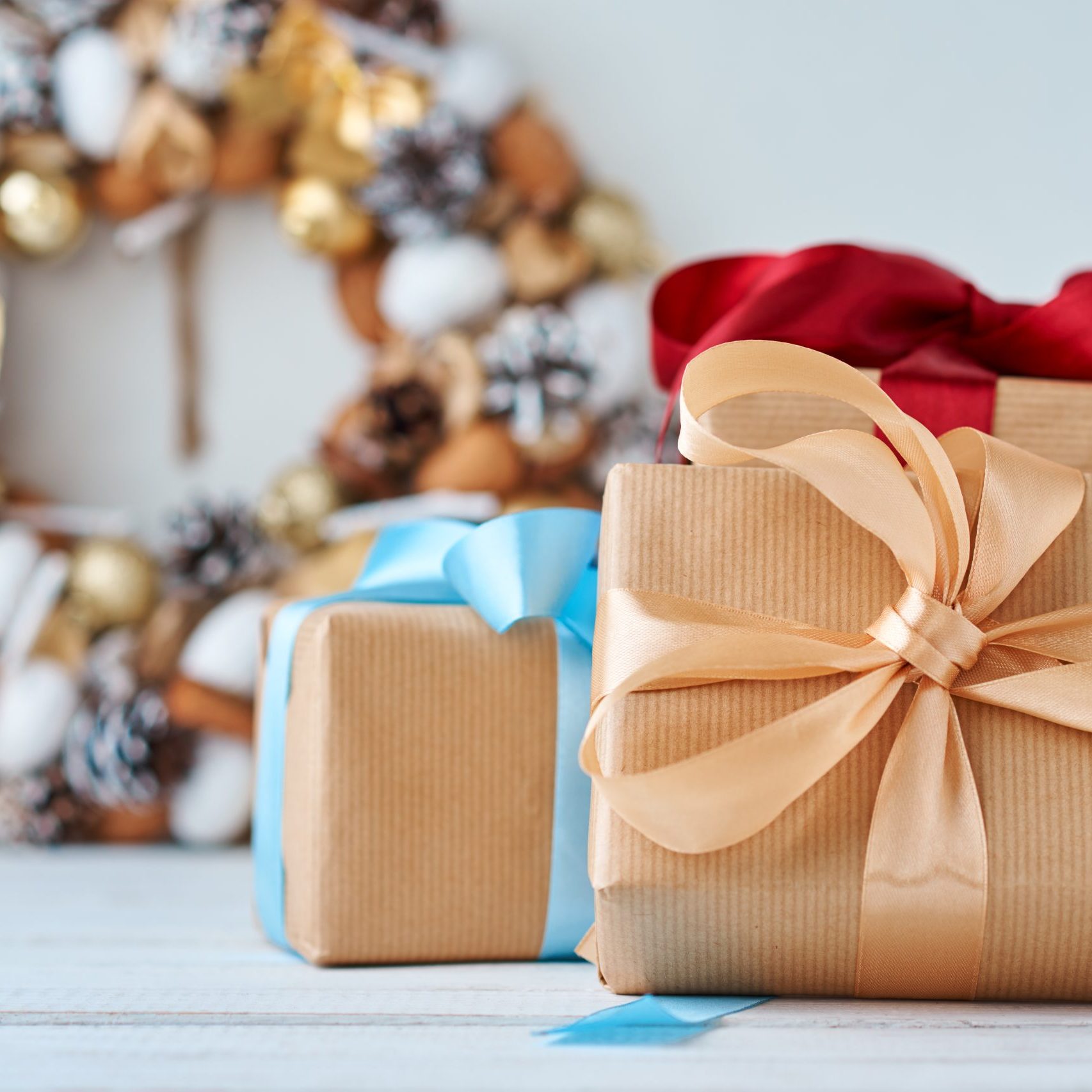 Christmas gift box with ribbon and christmas decorations on a wh Christmas gift box with ribbon and christmas decorations on white background, close up